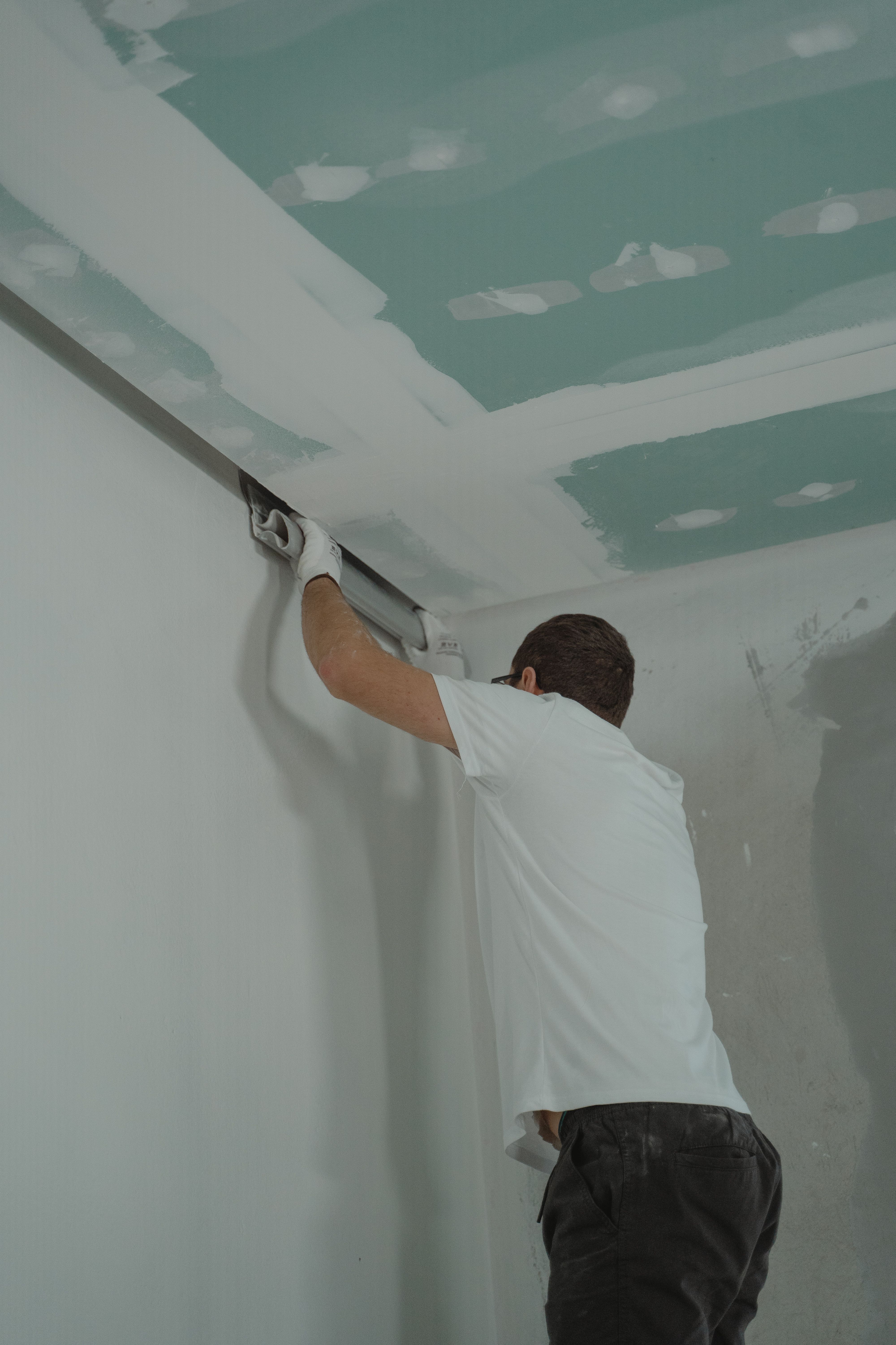 Drywall professional working on interior wall finishing